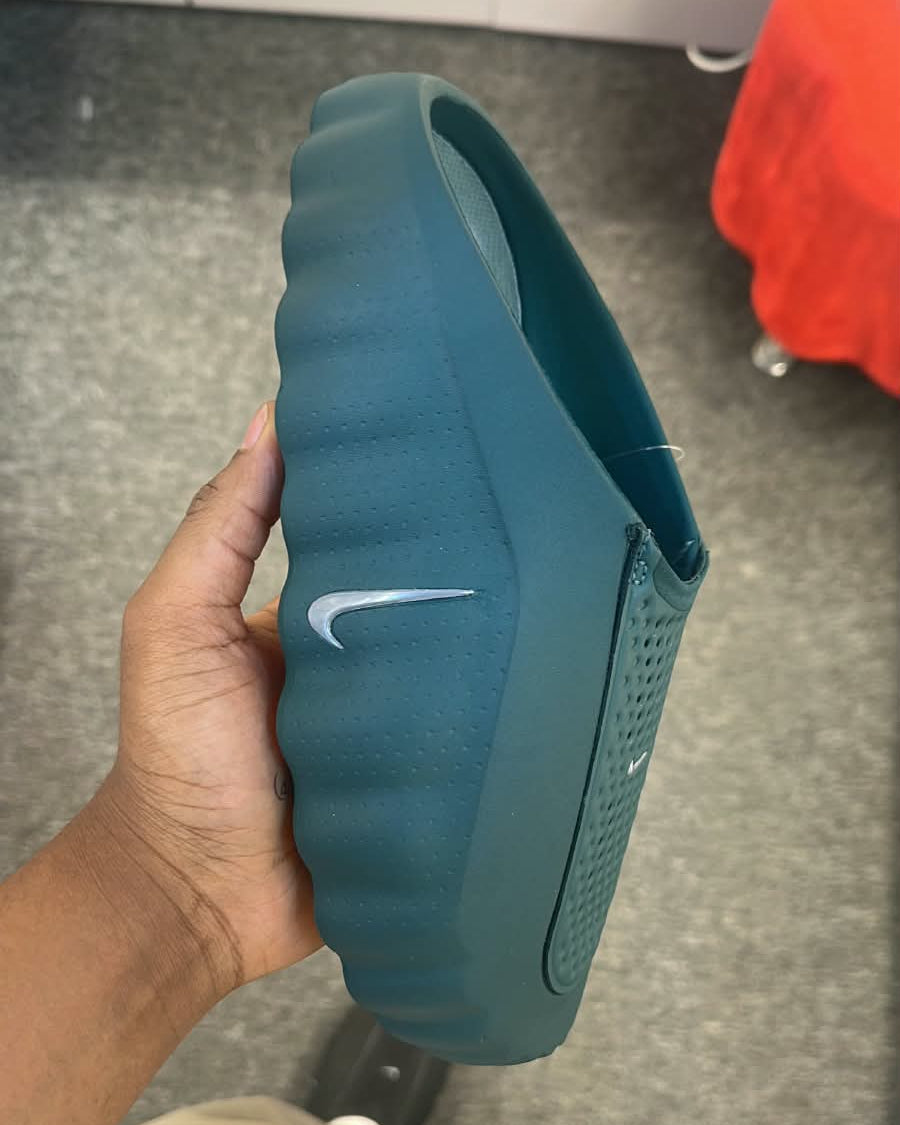 Nike Mind 001 slide in mineral slate color, featuring a comfortable slide sandal with Nike branding and textured footbed.
