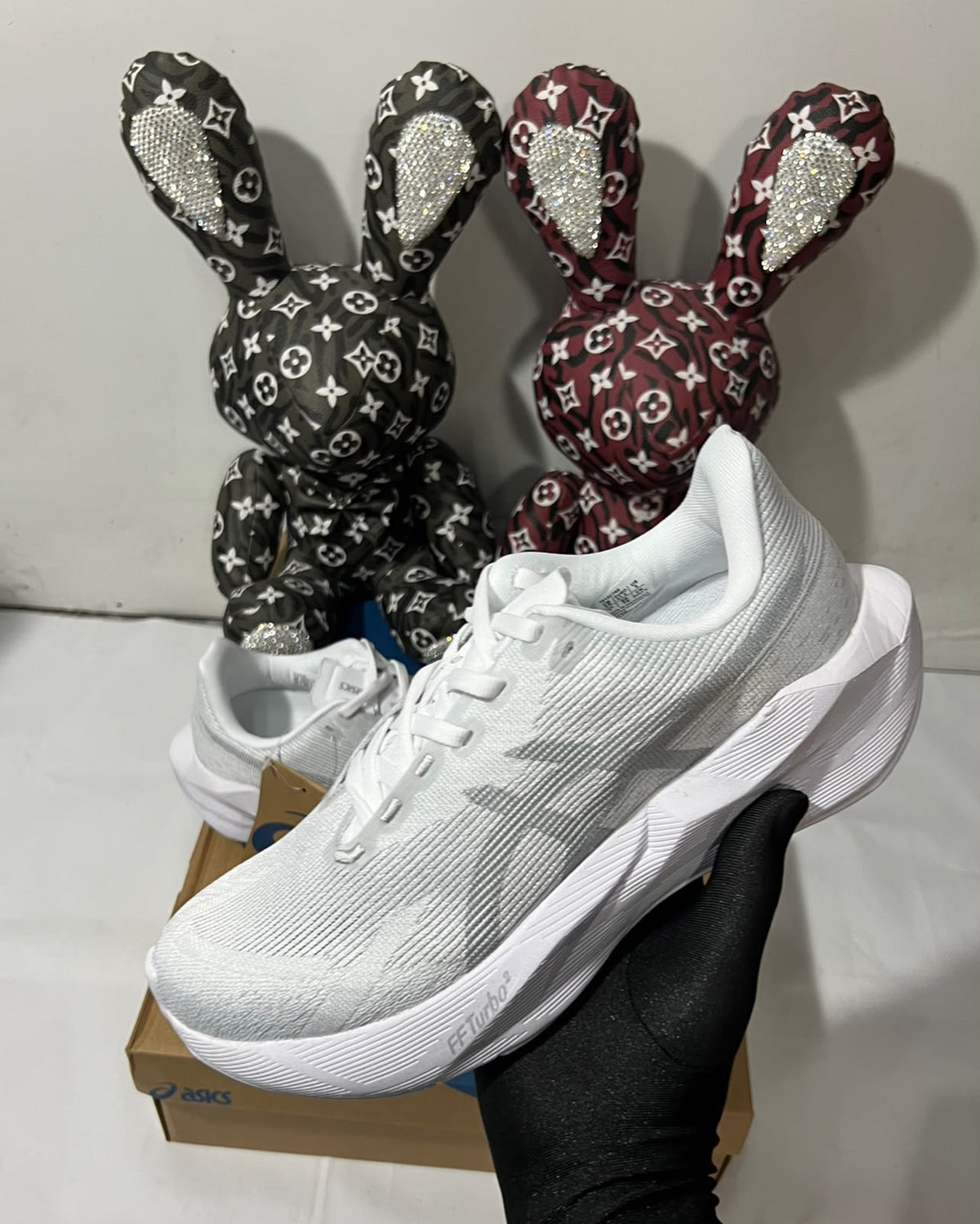 White ASICS NOVABLAST 6 running shoes with breathable mesh upper and cushioned midsole, designed for comfort and performance.