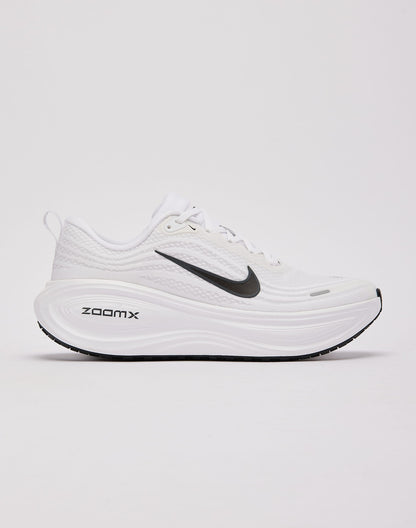 White Nike Vomero Plus running shoes featuring sleek design and breathable mesh for comfortable athletic wear.