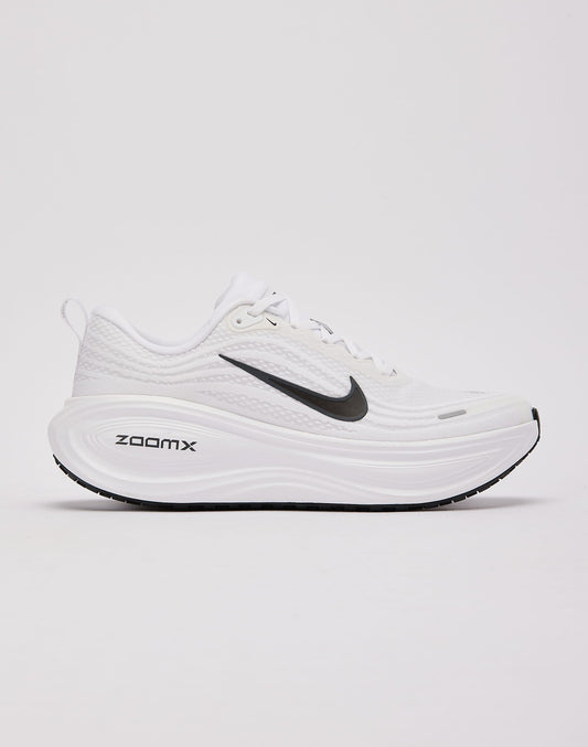 White Nike Vomero Plus running shoes featuring sleek design and breathable mesh for comfortable athletic wear.