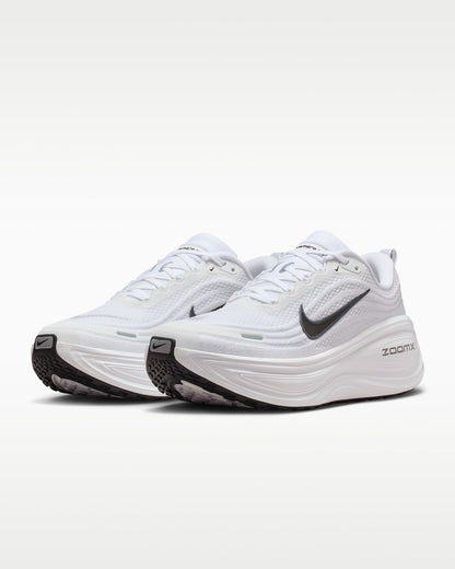 Nike Vomero Plus white running shoes with Nike branding, featuring a sleek white design and cushioned soles for comfort.
