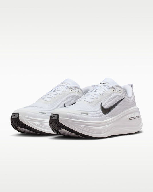 Nike Vomero Plus white running shoes with Nike branding, featuring a sleek white design and cushioned soles for comfort.