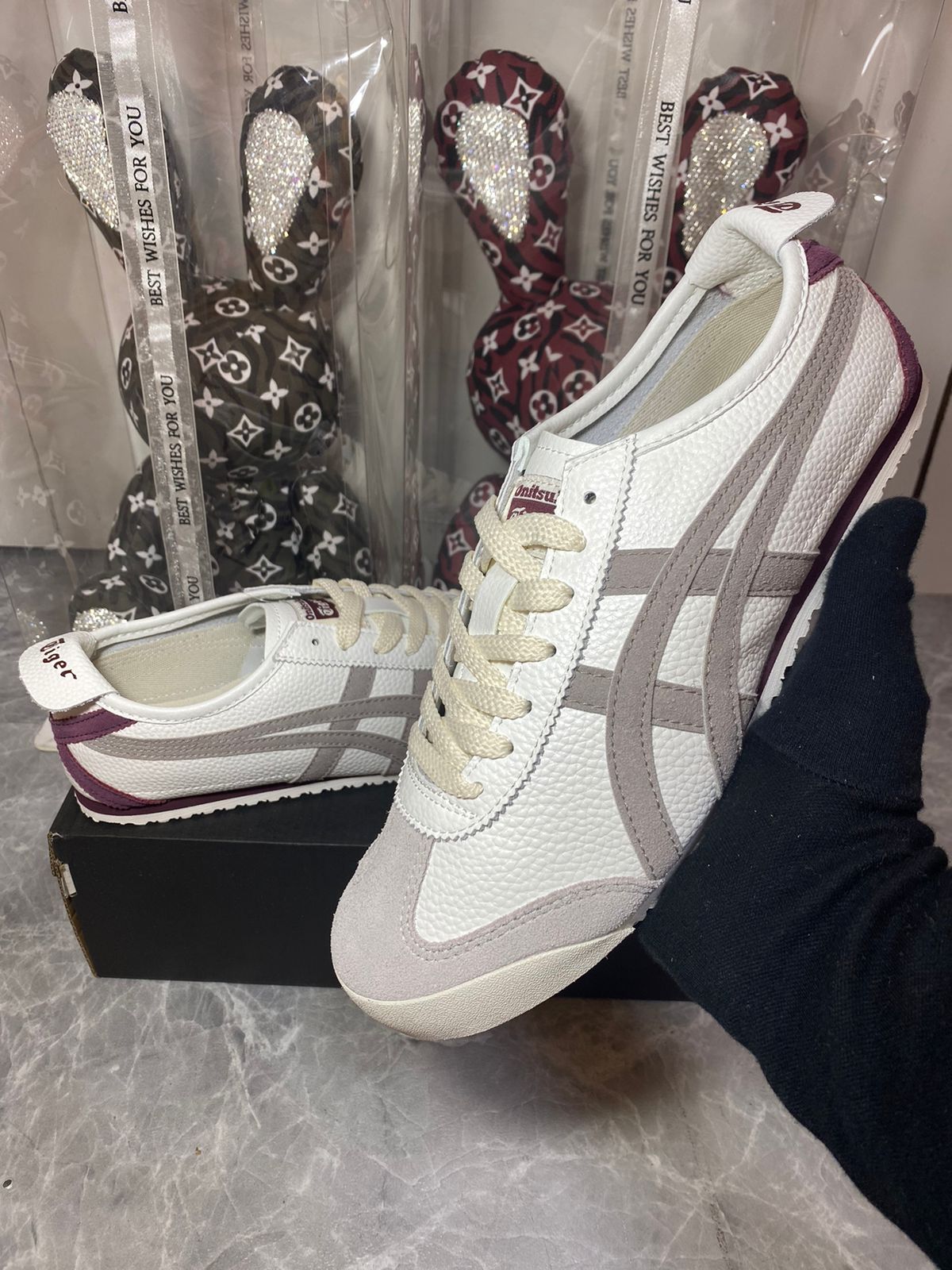 Beige and burgundy Onitsuka Tiger Mexico 66 sneakers with white laces and retro athletic style, shown from a side angle.