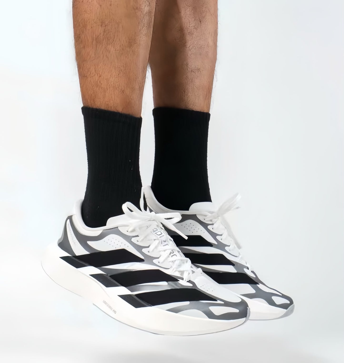 Adidas Adizero EVO SL EXO running shoes in white, black, and silver with sleek design and breathable mesh upper.