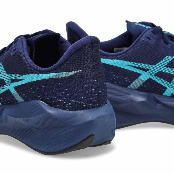 ASICS NOVABLAST 6 running shoes in Midnight and Energy Aqua with breathable mesh upper and cushioned sole, displayed on a white background.