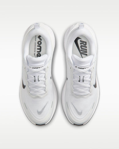 Nike Vomero Plus white running shoes with breathable mesh and cushioned soles, designed for comfort and performance.